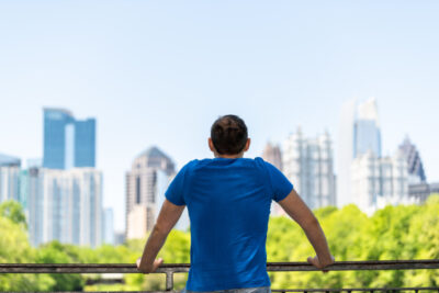 Young man standing leaning on railing