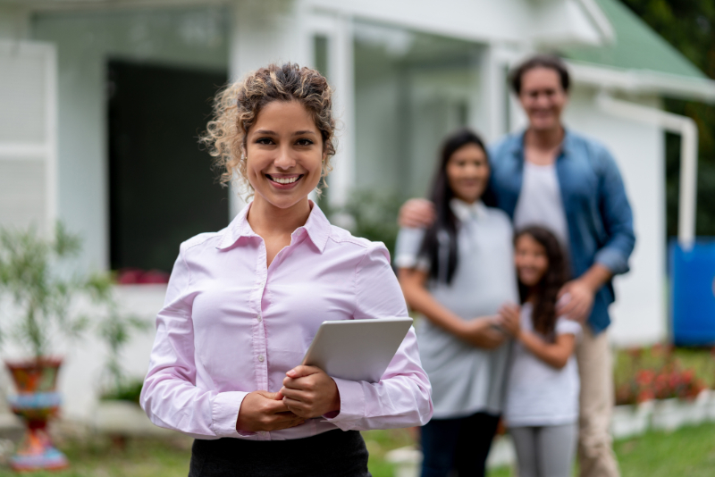 smiling family and real estate agent