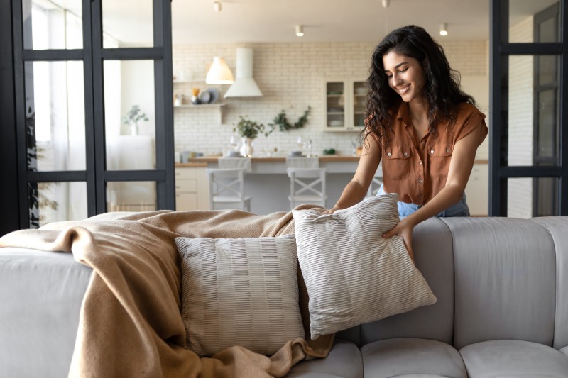 woman putting soft pillows